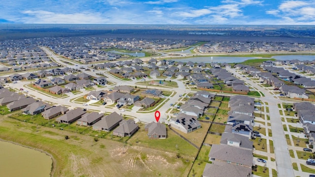 birds eye view of property featuring a water view and a residential view