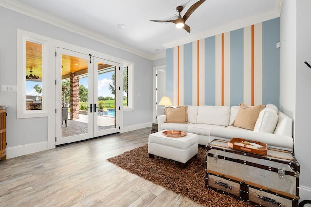 living area with a ceiling fan, baseboards, crown molding, and wood finished floors
