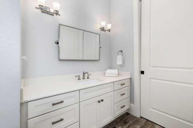 bathroom featuring vanity and wood finished floors