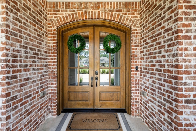 property entrance with french doors and brick siding