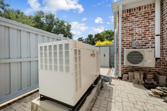 details with brick siding, a power unit, ac unit, and fence