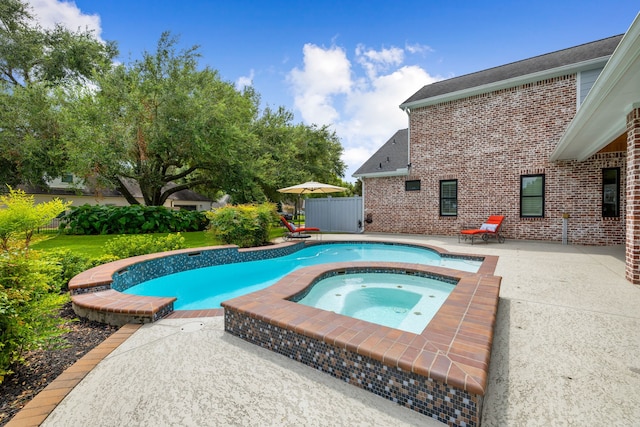 view of pool featuring fence, a patio, a fenced in pool, and an in ground hot tub