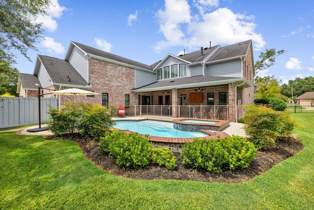 rear view of property featuring a lawn, fence, a patio, brick siding, and ceiling fan