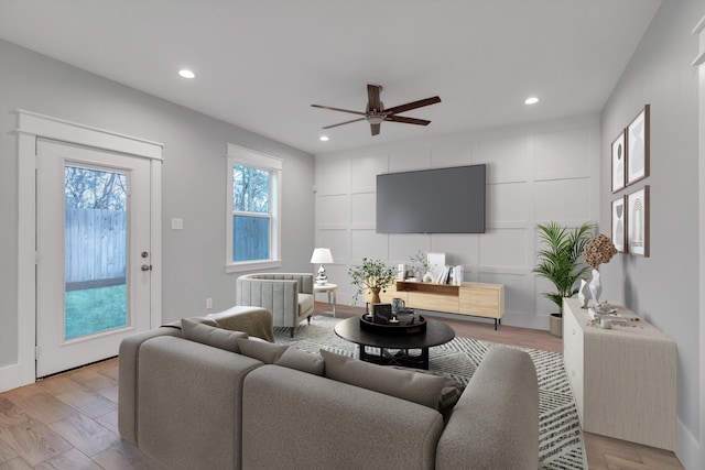 living area with recessed lighting, light wood finished floors, and ceiling fan