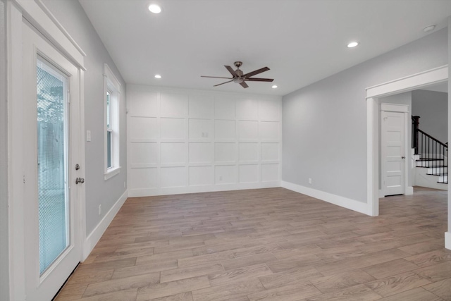 empty room featuring light wood-style flooring, stairway, recessed lighting, and ceiling fan