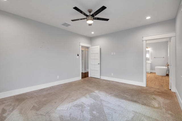 unfurnished bedroom featuring recessed lighting, carpet, visible vents, and baseboards