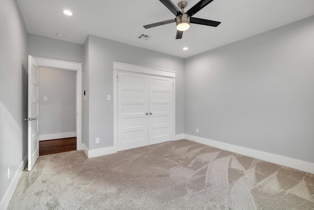 unfurnished bedroom with baseboards, recessed lighting, visible vents, a closet, and carpet floors