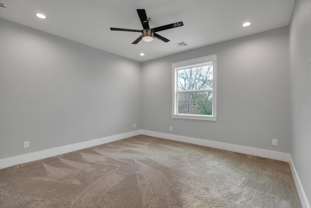 spare room featuring recessed lighting, visible vents, a ceiling fan, baseboards, and carpet flooring