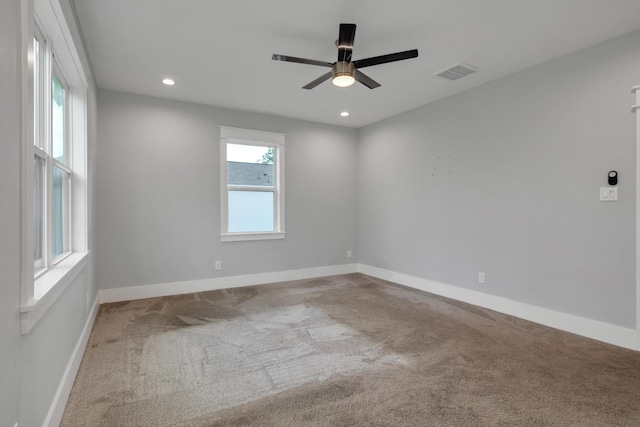 carpeted empty room with baseboards, a ceiling fan, visible vents, and recessed lighting