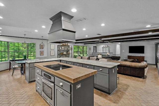 1492 Sleepy Hollow Ln, Canton, TX 75103 - kitchen featuring oven, butcher block counters, brick floor, gray cabinets, and a kitchen island