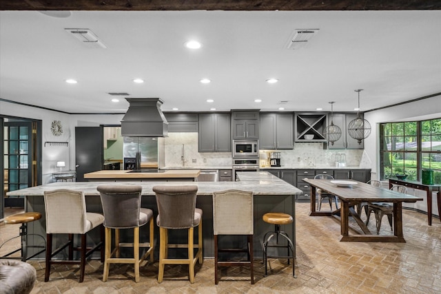 1492 Sleepy Hollow Ln, Canton, TX 75103 - kitchen featuring visible vents, gray cabinets, stainless steel appliances, custom range hood, and a spacious island