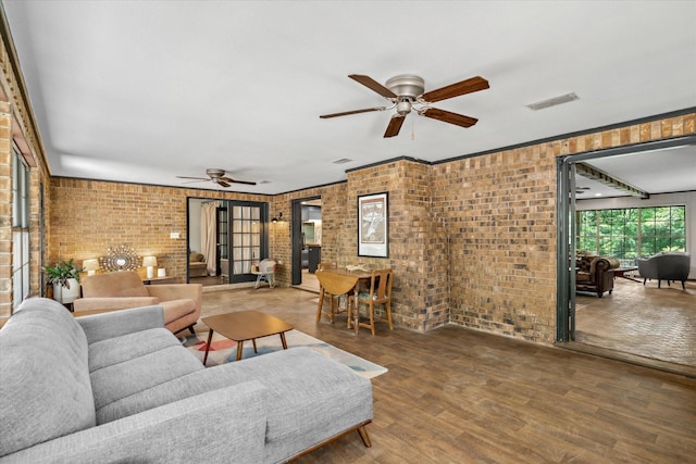 1492 Sleepy Hollow Ln, Canton, TX 75103 - living room with brick wall, wood finished floors, a ceiling fan, and visible vents
