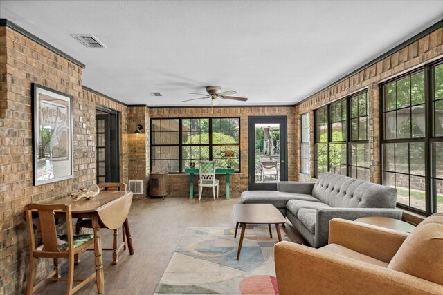 1492 Sleepy Hollow Ln, Canton, TX 75103 - sunroom / solarium featuring visible vents, brick wall, and wood finished floors