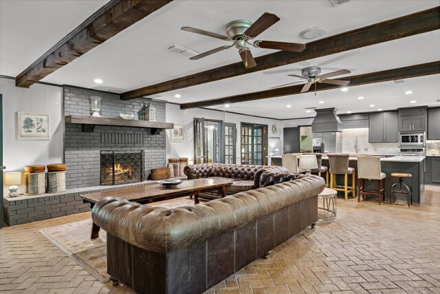 1492 Sleepy Hollow Ln, Canton, TX 75103 - living area with visible vents, a ceiling fan, brick floor, beam ceiling, and a brick fireplace
