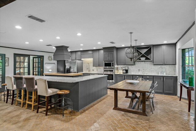 1492 Sleepy Hollow Ln, Canton, TX 75103 - kitchen with a large island, tasteful backsplash, stainless steel appliances, and visible vents