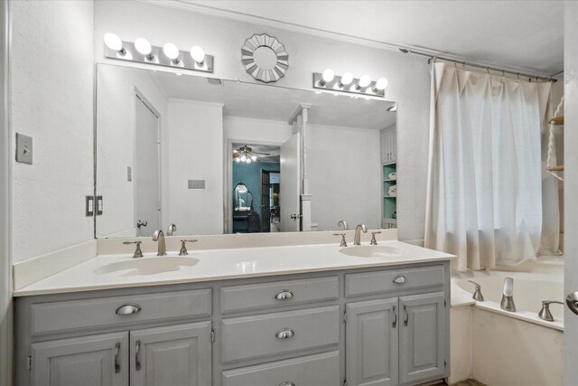 1492 Sleepy Hollow Ln, Canton, TX 75103 - bathroom featuring double vanity, a sink, a ceiling fan, and a washtub