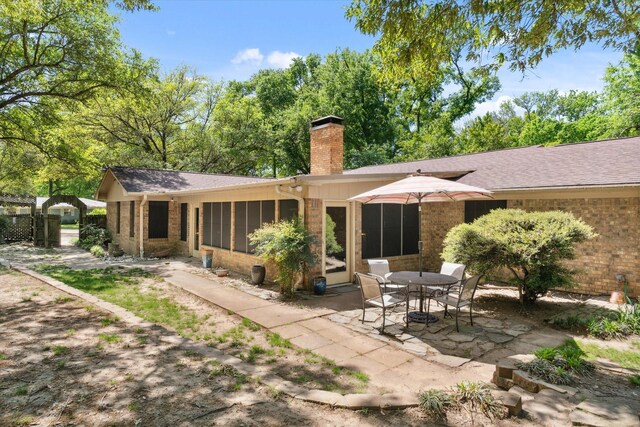 1492 Sleepy Hollow Ln, Canton, TX 75103 - back of house with a sunroom, a patio, brick siding, and a chimney