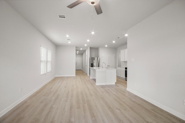 21429 Mary Myrtle St, Spring, TX 77379 - unfurnished living room featuring light wood-type flooring, ceiling fan, and recessed lighting