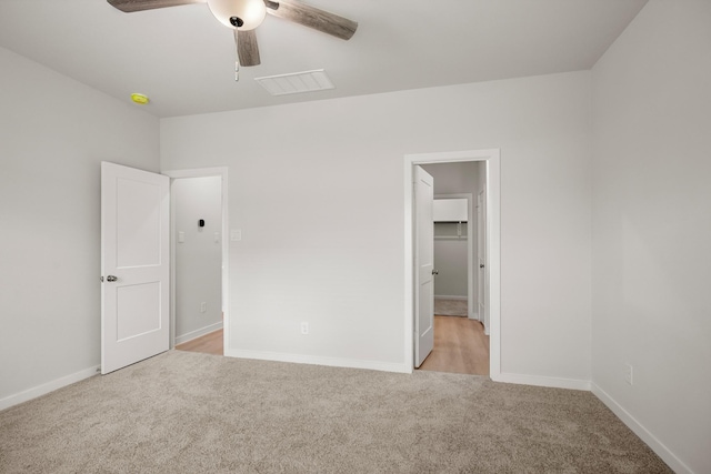 21429 Mary Myrtle St, Spring, TX 77379 - unfurnished bedroom featuring light colored carpet, a walk in closet, and a ceiling fan
