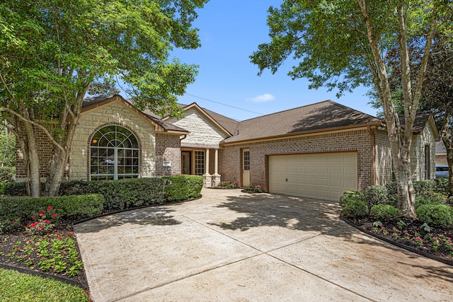 view of front facade featuring concrete driveway, brick siding, and a garage