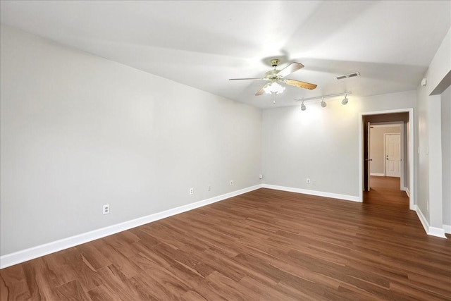 spare room with baseboards, a ceiling fan, visible vents, and rail lighting
