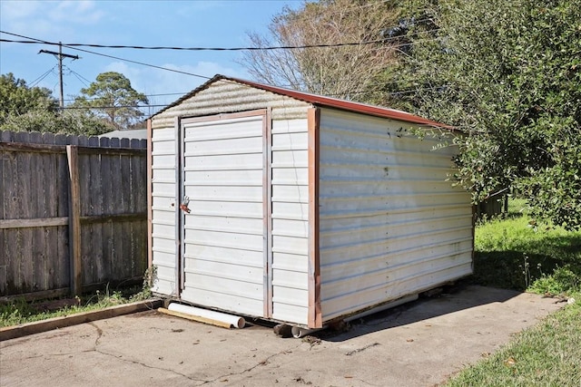 view of shed with fence