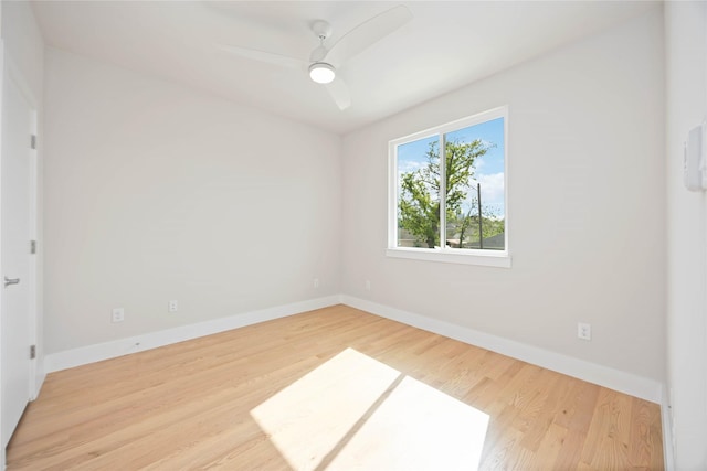 spare room with ceiling fan, baseboards, and wood finished floors