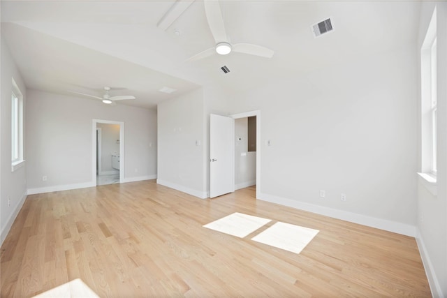 spare room with light wood finished floors, baseboards, a ceiling fan, and visible vents