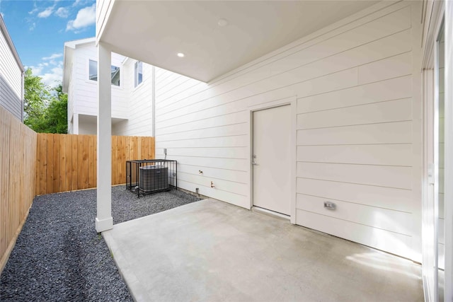 view of patio with fence and central air condition unit
