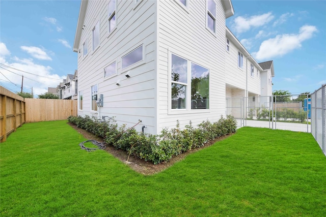 view of property exterior featuring a lawn and a fenced backyard