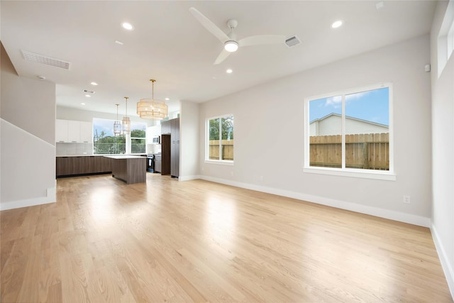 unfurnished living room featuring recessed lighting, visible vents, and baseboards