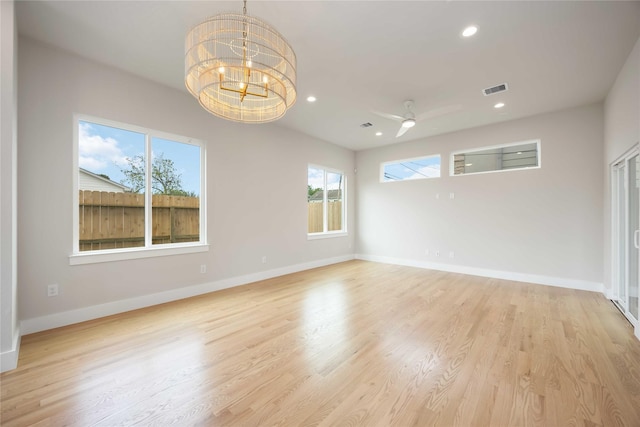unfurnished room featuring baseboards, visible vents, recessed lighting, and a chandelier