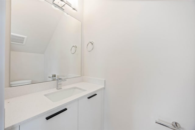 1810 Yates St, Houston, TX 77020 - bathroom with vanity, lofted ceiling, and toilet