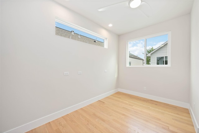 empty room featuring light wood finished floors and baseboards