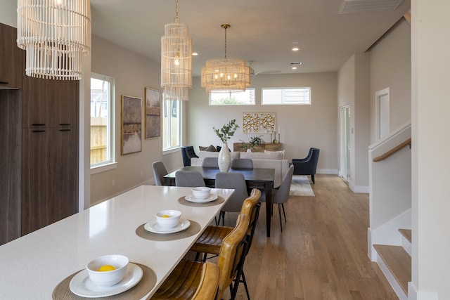 1810 Yates St, Houston, TX 77020 - dining space with a chandelier, light wood-style flooring, recessed lighting, and baseboards
