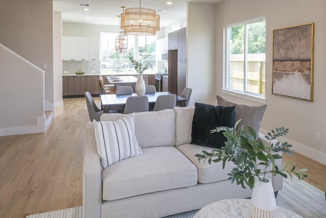 1810 Yates St, Houston, TX 77020 - living area featuring baseboards, a chandelier, light wood-style flooring, and recessed lighting
