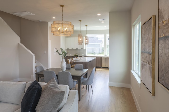 1810 Yates St, Houston, TX 77020 - dining room featuring light wood-style flooring, a chandelier, recessed lighting, baseboards, and stairway