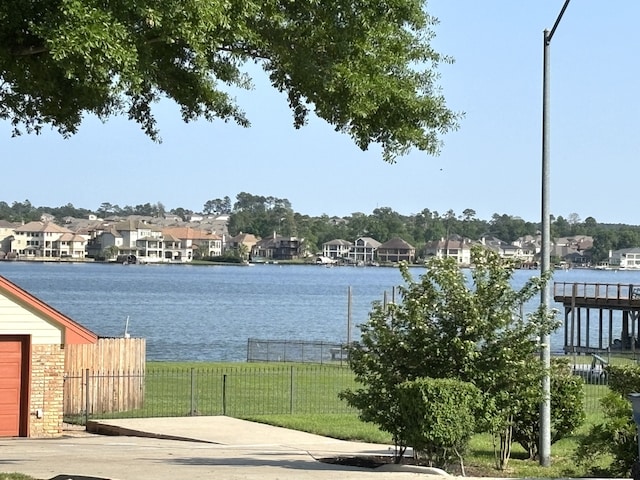 9834 E Shore Dr, Willis, TX 77318 - water view featuring nearby suburban area and fence