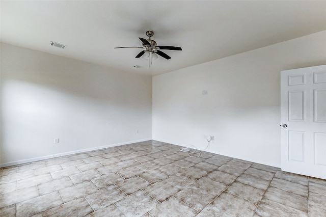 spare room with baseboards, visible vents, and ceiling fan