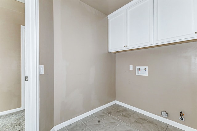 clothes washing area featuring baseboards, cabinet space, hookup for a washing machine, and hookup for a gas dryer