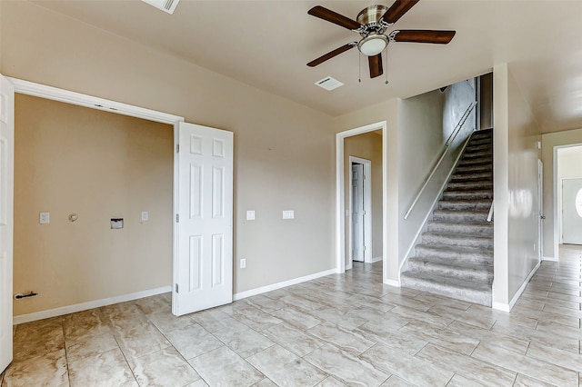 unfurnished room with baseboards, visible vents, a ceiling fan, and stairs