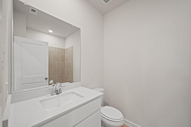 bathroom featuring toilet and vanity
