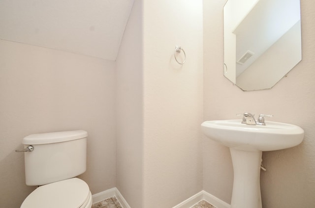 half bathroom featuring baseboards, visible vents, and toilet