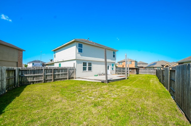 rear view of property with a fenced backyard, a patio, and a lawn