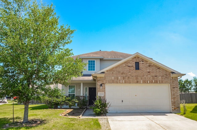 traditional-style house featuring a front lawn, brick siding, driveway, and a garage
