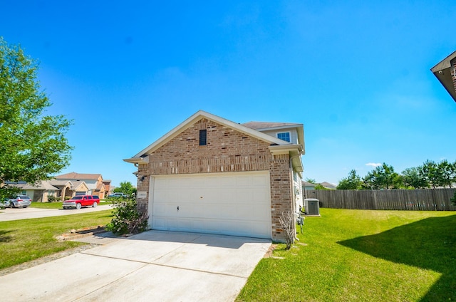 view of side of home featuring fence, a lawn, driveway, and brick siding