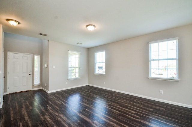 entrance foyer with dark wood-style floors, baseboards, and visible vents