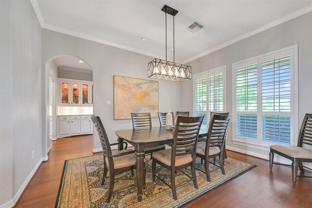 314 Del Monte Dr, Friendswood, TX 77546 - dining space featuring visible vents, dark wood-style floors, arched walkways, and ornamental molding