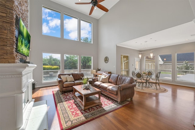 314 Del Monte Dr, Friendswood, TX 77546 - living room with a ceiling fan, wood finished floors, high vaulted ceiling, and a fireplace