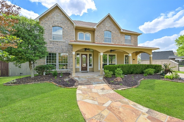 314 Del Monte Dr, Friendswood, TX 77546 - view of front of property featuring brick siding, fence, a ceiling fan, and a front yard